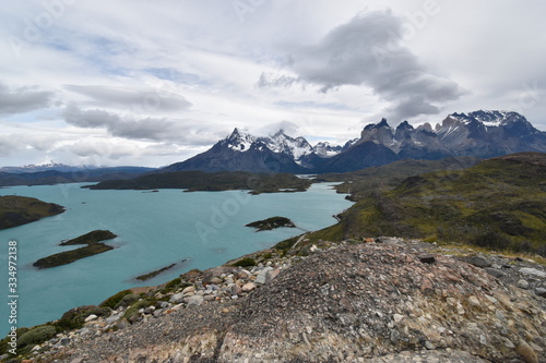 Snow covered mountains with the light blue ocean in front in Torres del Paine National Park in Chile, Patagonia 