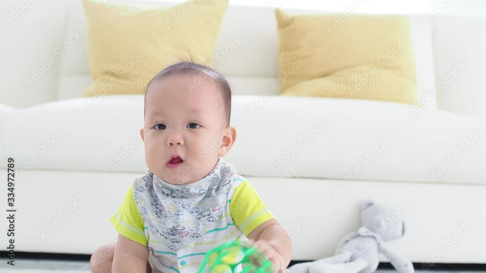 Little asian boy sitting on the floor and playing toys. Little asian boy sitting on the floor and playing toys.