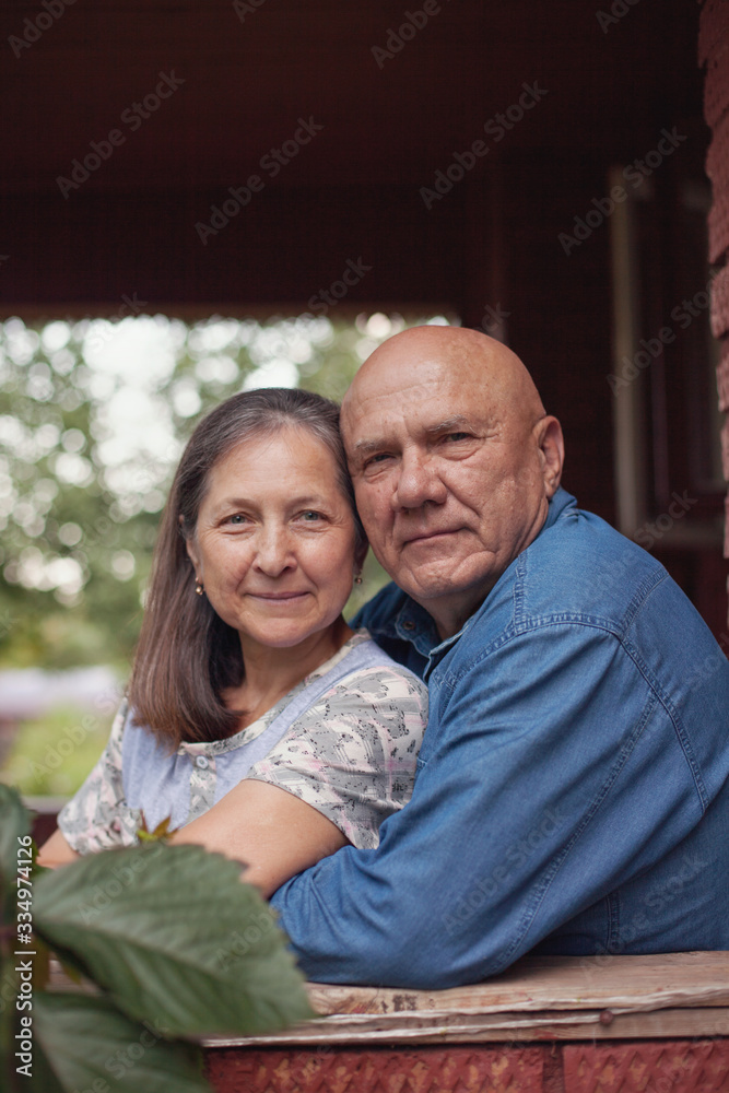 Fototapeta premium pensioners on porch of house in village.