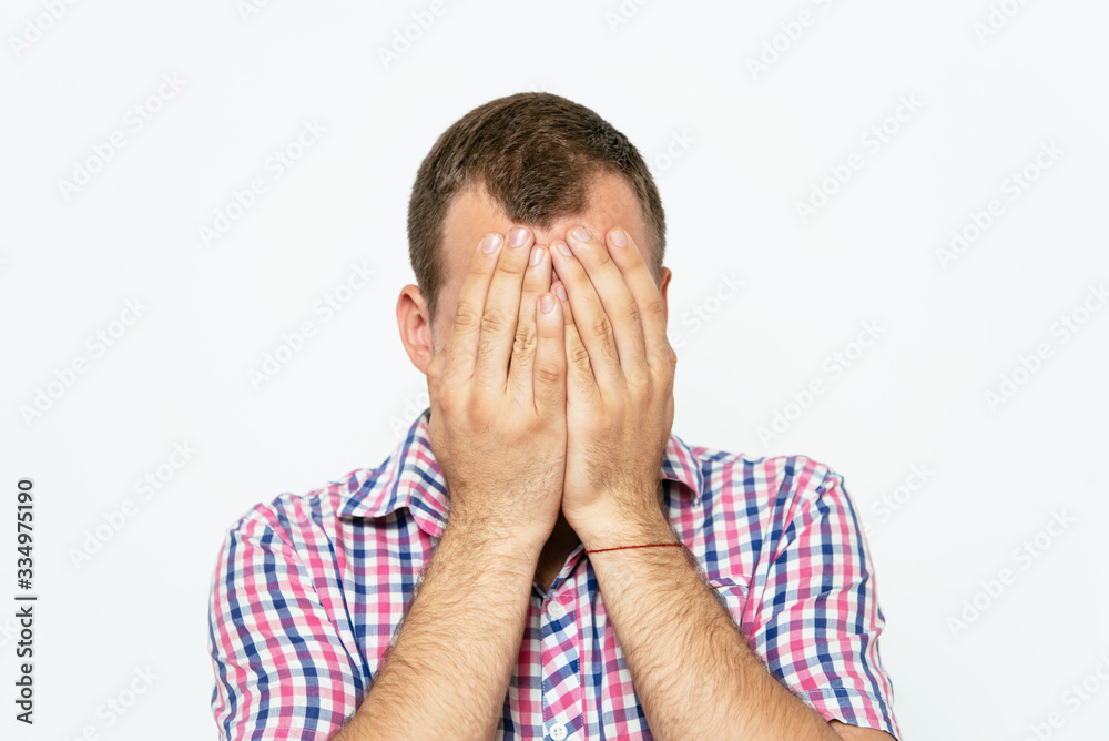 Man covering his face Man covering his face