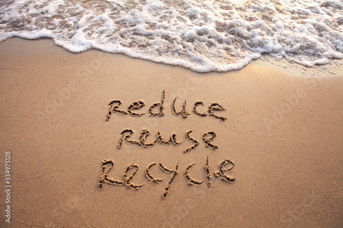 reduce reuse recycle concept drawn on sand, sustainability