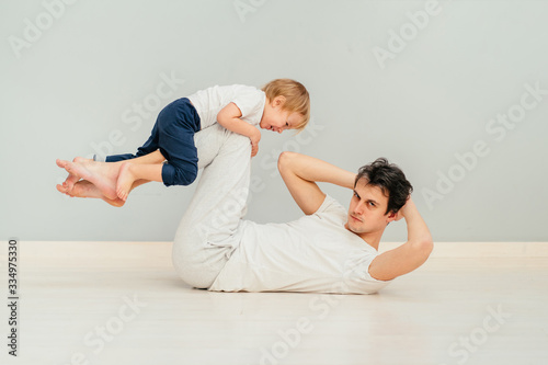 Strong purposeful father babysitting a child and trying