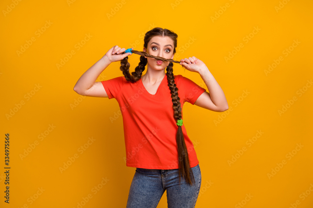 Photo of attractive pretty funny lady hold hands long pigtail making mustache like guy weekend good mood wear casual red t-shirt jeans isolated vibrant yellow color background Photo of attractive pretty funny lady hold hands long pigtail making mustache like guy weekend good mood wear casual red t-shirt jeans isolated vibrant yellow color background