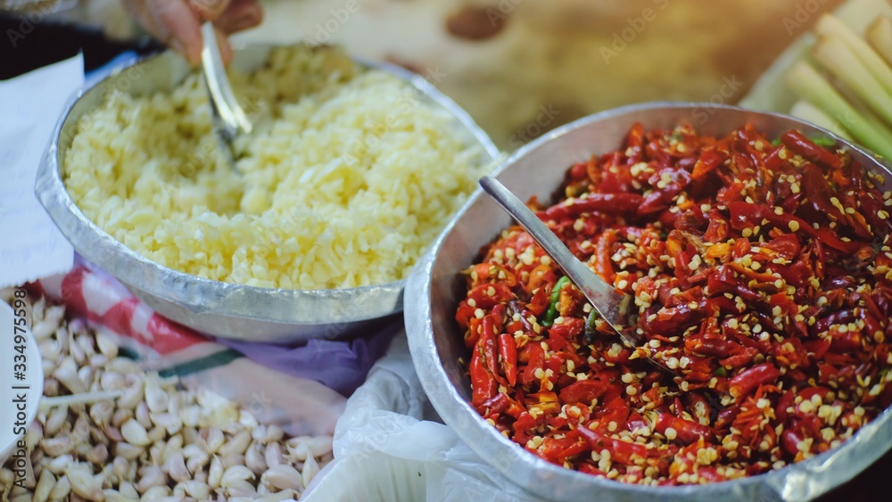 Close up red chilli and blurred focus of garlic in kitchen , fresh natural ingredients organic of Thai food. Close up red chilli and blurred focus of garlic in kitchen , fresh natural ingredients organic of Thai food.