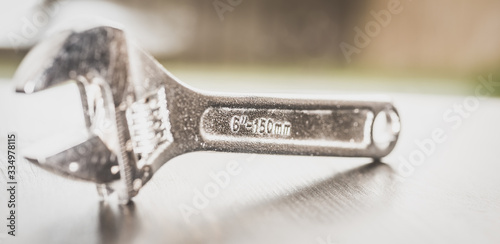Wrench, French key, on blurred background