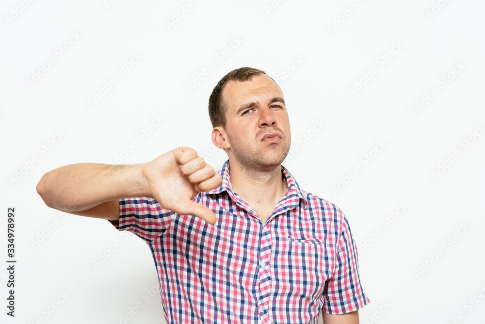 man showing a thumb down gesture man showing a thumb down gesture