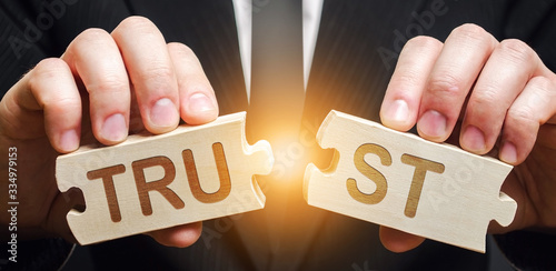 A man shares two puzzles with the word Trust. Violation of agreements and promises. Lose credibility. Failed to maintain professional reputation. Lie and cheat. Bad consequences. Not trustworthy