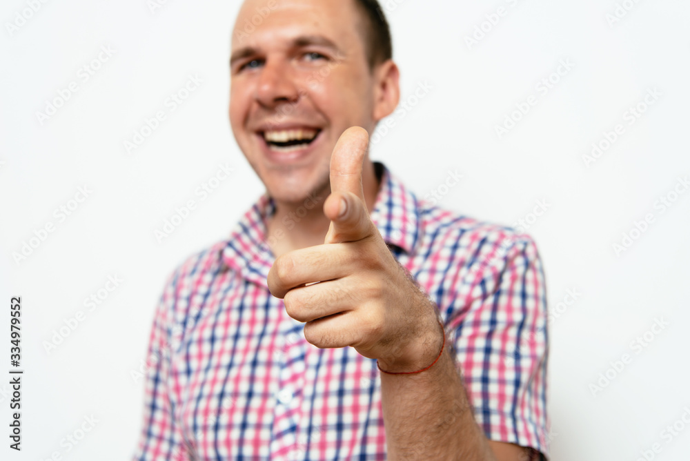 Young man showing his index finger towards the camera Young man showing his index finger towards the camera