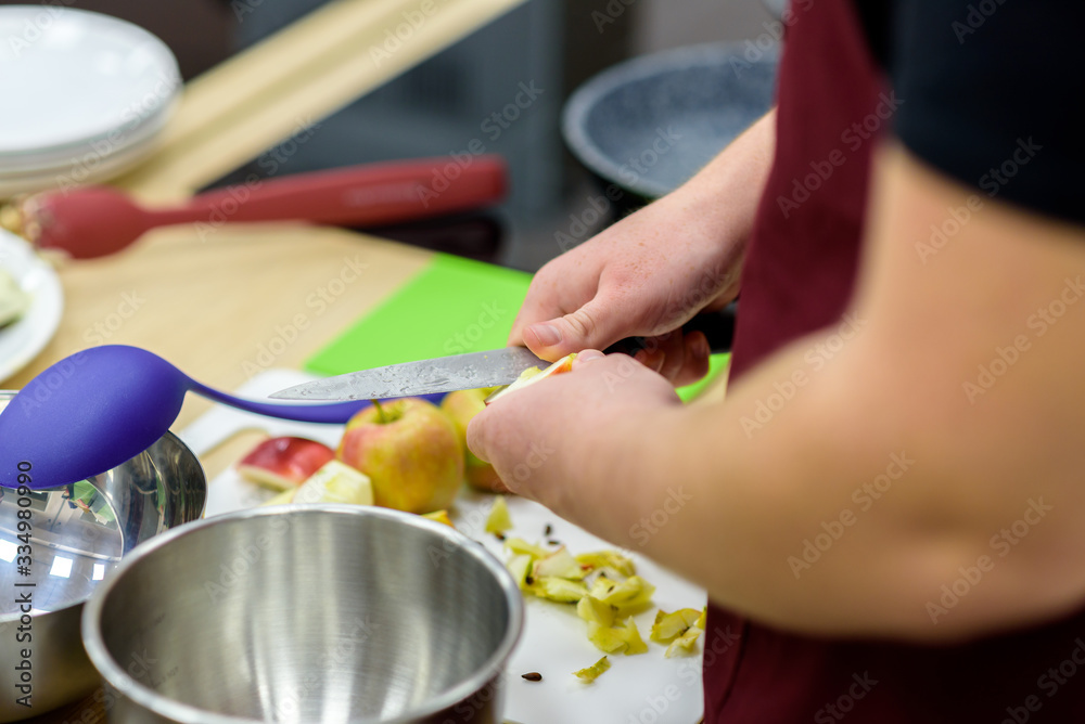 Man cooking pie, cuts an apple, top view. Man cooking pie, cuts an apple, top view.