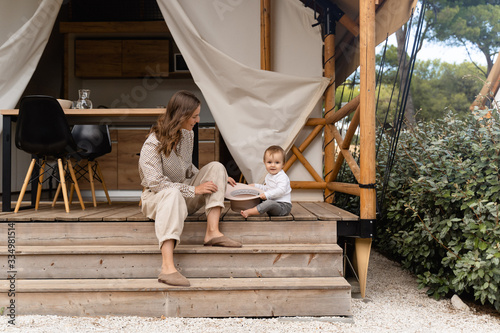 mother with baby sitting on the bench