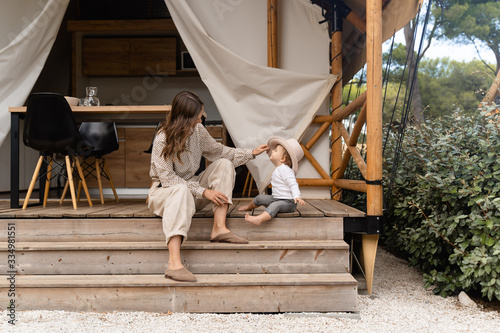 mother with baby sitting on the bench