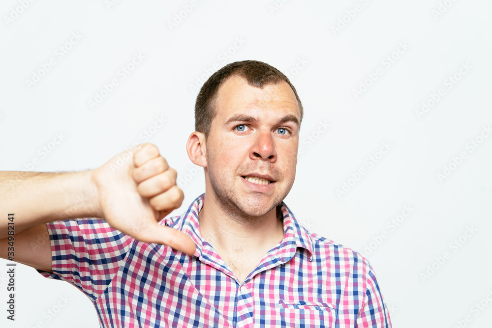 man showing a thumb down gesture man showing a thumb down gesture