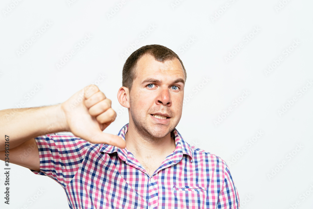 man showing a thumb down gesture man showing a thumb down gesture