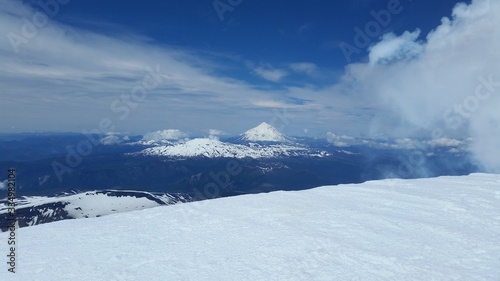 landscape with mountains, volcano and blue sky