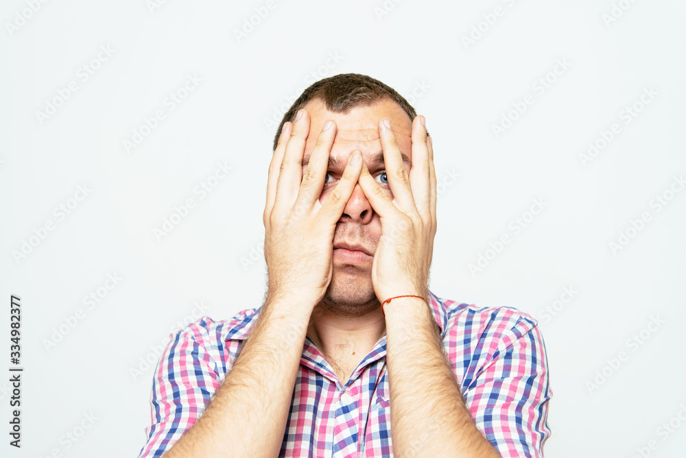 Young businessman holding head in his hands Young businessman holding head in his hands