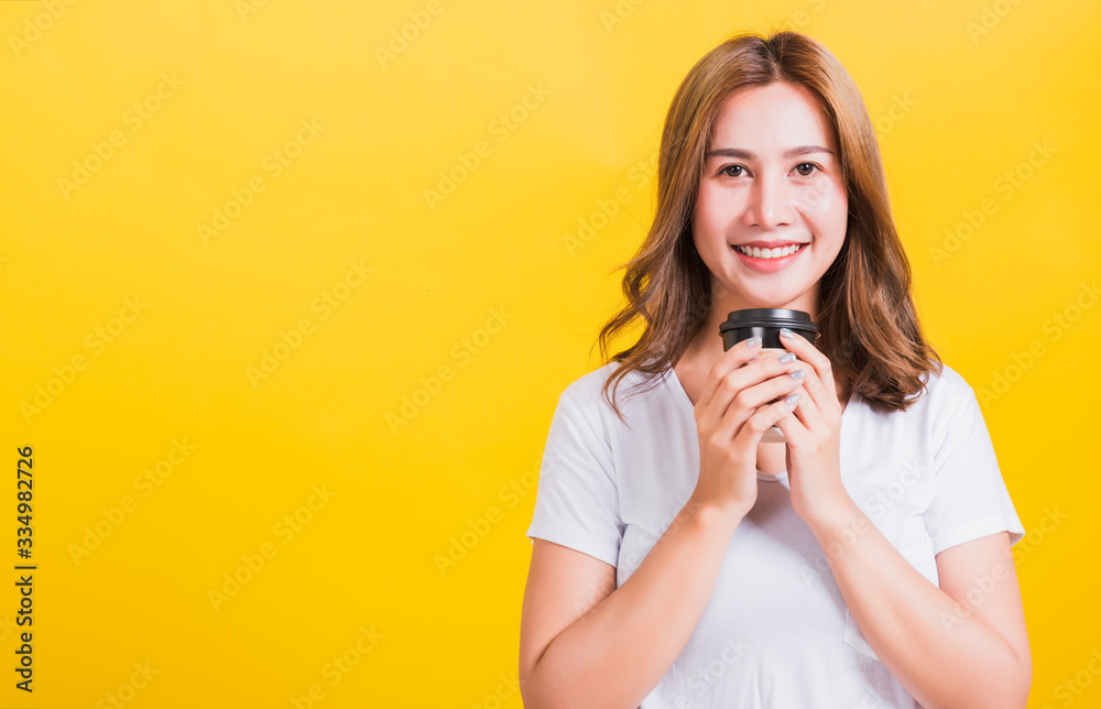woman smiling holding take away coffee paper cup