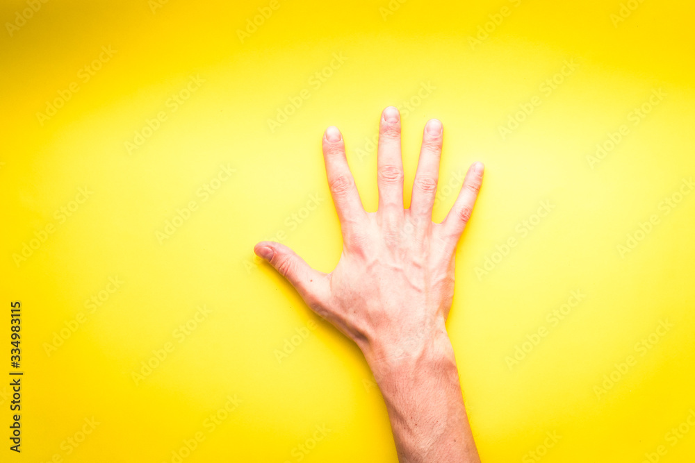 A White Man's Right Hand on a Yellow Background A White Man's Right Hand on a Yellow Background