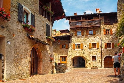 Beautiful medieval village near the lake Lago di Garda, hisoric village in the mountains with houses with stone walls and flowers in the windows, cobbled streets