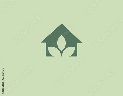 Creative green logo icon house and inside three leaf plants for your company. Eco technology.