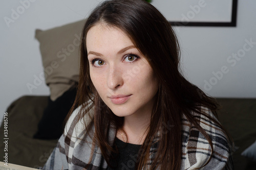 photo of a young beautiful pensive girl at home