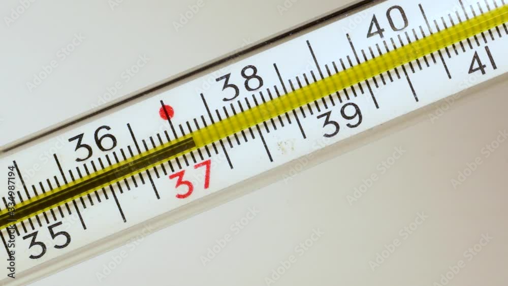 Mercury in classic thermometer moves higher on scale, showing temperature Mercury in classic thermometer moves higher on scale, showing temperature