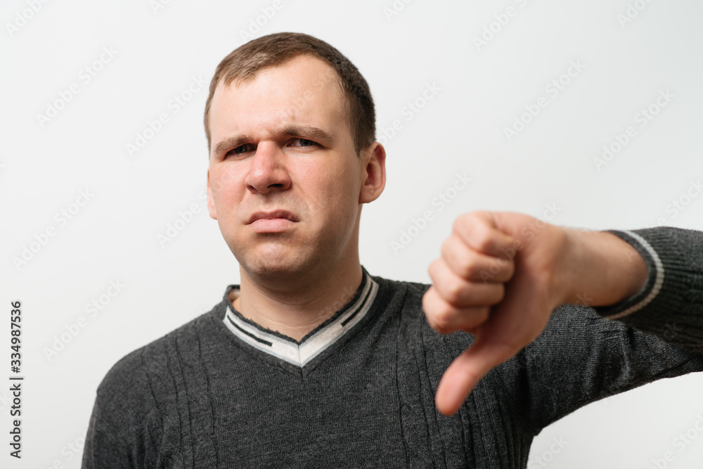 man showing a thumb down gesture man showing a thumb down gesture