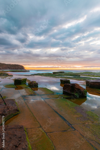 Rocky platform at Turimetta Beach, Sydney, during low tide in the morning.