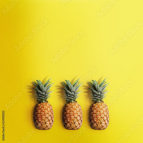 Pinapple on pastel yellow background. Exotic fruits background.
