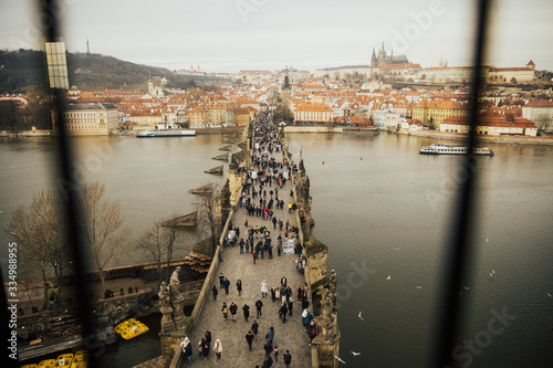 Scenic view of Charles Bridge  and Lesser Town Tower Prague symbol, Czech Republic, Europe. Panorama of Prague with red roofs from above.  Charles bridge and Prague castle in the early morning.