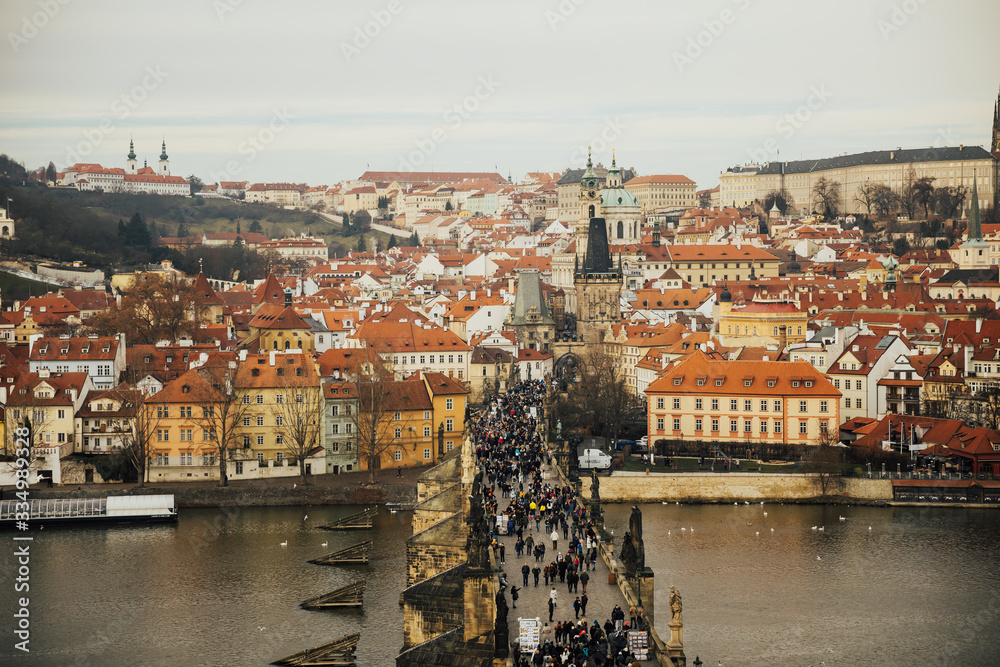 Prague is very popular tourist destination. Scenic winter aerial view of the Old Town pier architecture and Charles Bridge over Vltava river  in Prague, Czech Republic. Top view from Lesser Town Tower