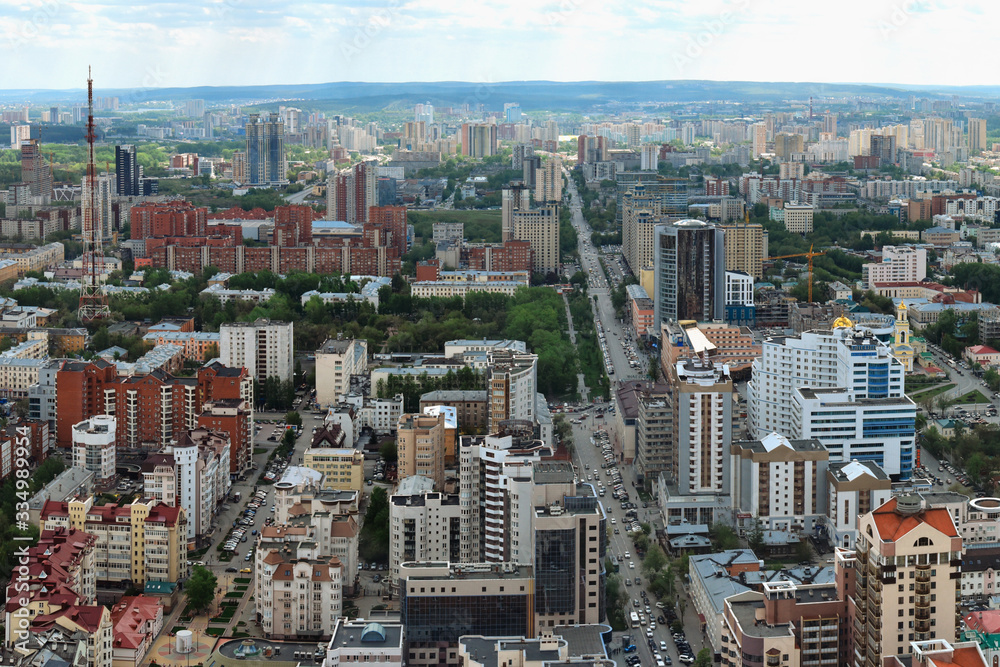 Yekaterinburg, the capital of the Urals, aerial view. Many beautiful residential and commercial buildings, as well as the architectural ensemble of the city, under the summer sun, top view.