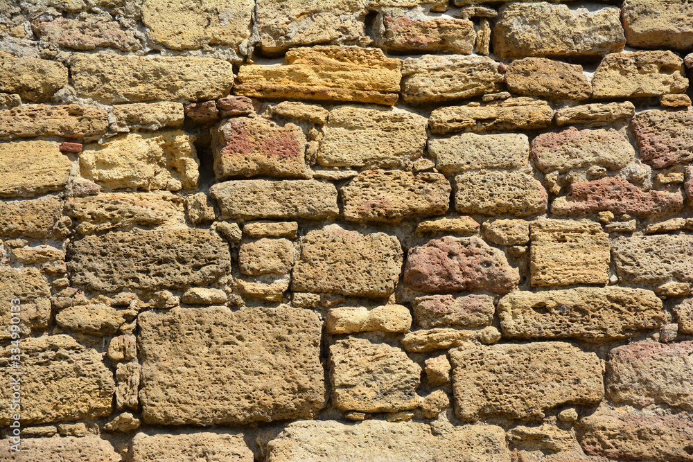 Masonry construction of medieval fortress wall made of limestone. Masonry construction of medieval fortress wall made of limestone.