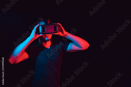 young man using VR virtual reality glasses headset © Anastasia