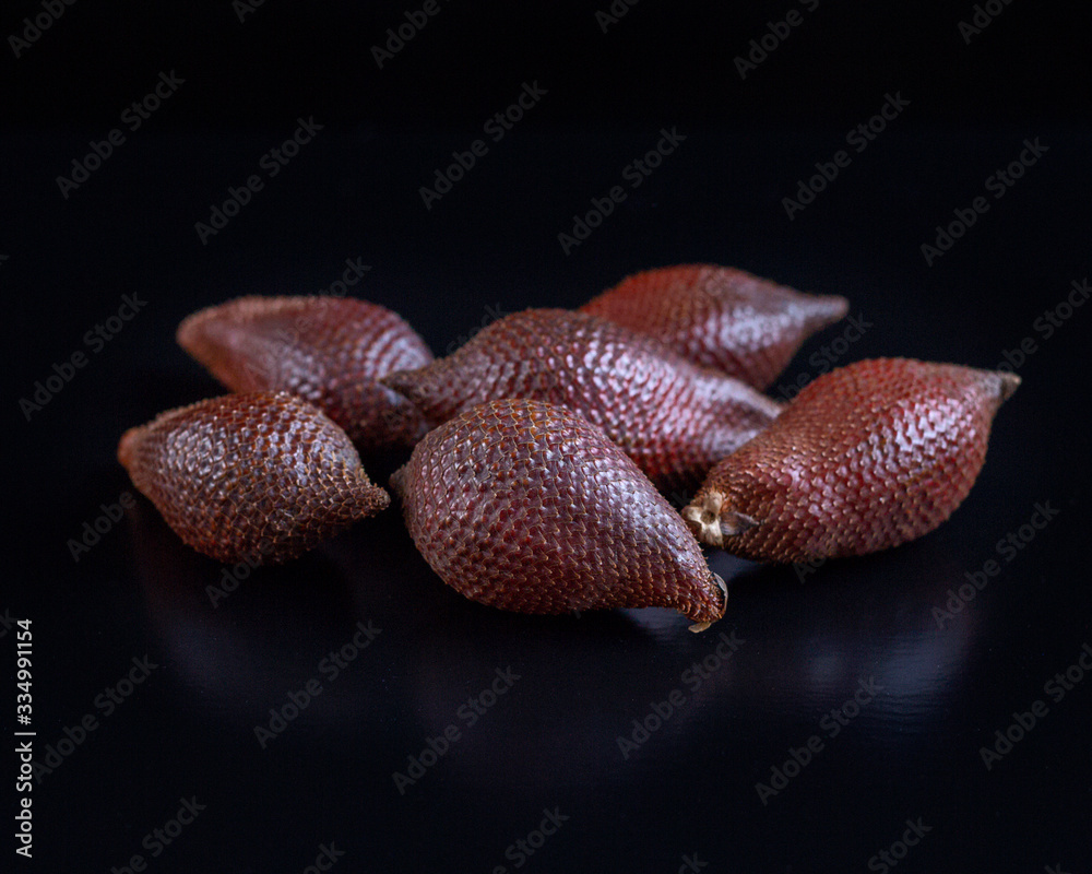 Snake fruit salak on black background. Exotic fruit. HLS. Selective focus. Сloseup. Snake fruit salak on black background. Exotic fruit. HLS. Selective focus. Сloseup.