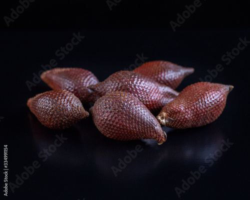 Snake fruit salak on black background. Exotic fruit. HLS. Selective focus. Сloseup.