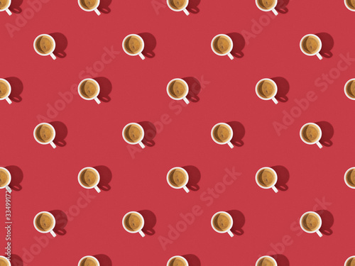 top view of cups of fresh coffee on red, seamless background pattern