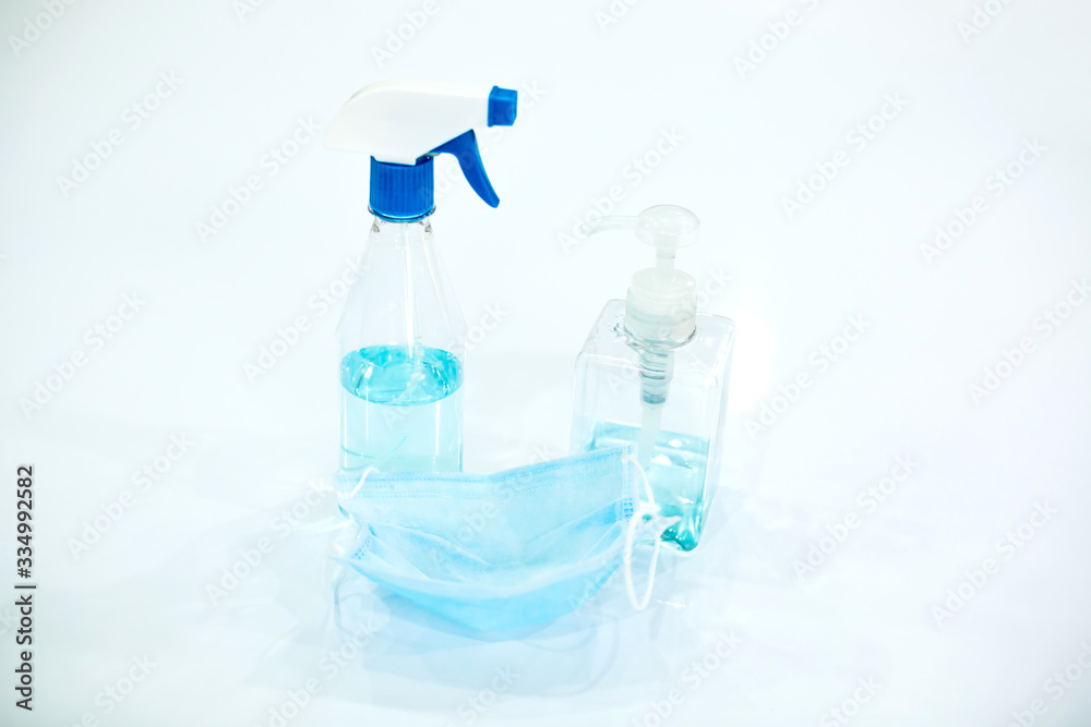 Alcohol spray with medical protective mask on white background, Prevent Coronavirus, protection factor for Coronavirus Covid 19. Alcohol spray with medical protective mask on white background, Prevent Coronavirus, protection factor for Coronavirus Covid 19.