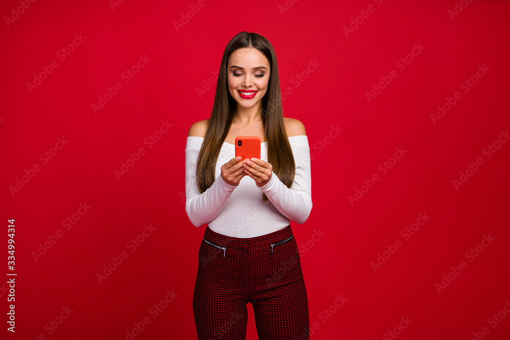 Portrait of positive classy fascinating girl use smartphone read social network news wear good look white sweater checkered trousers isolated over bright shine color background Portrait of positive classy fascinating girl use smartphone read social network news wear good look white sweater checkered trousers isolated over bright shine color background
