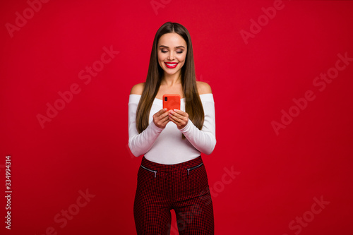 Portrait of positive classy fascinating girl use smartphone read social network news wear good look white sweater checkered trousers isolated over bright shine color background