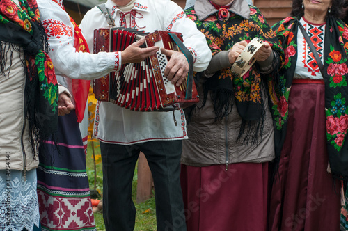 The folklore Belarusian amateur music group with an accordion performs folk songs. Traditional autumn harvest festival. People and traditions.