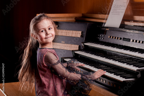 Little girl playing a pipe organ photo
