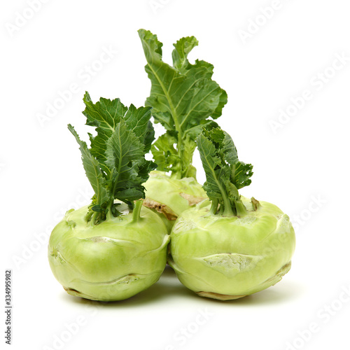 Fresh kohlrabi with green leaves on isolated white backround