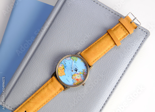 travel watch with world map on a notebook, isolated on white background
