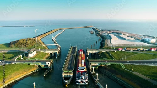 [One Minute Video] Enclosure Dam (Afsluitdijk): Large Cargo Ship Passing Through the Dam, Bridge is Open by Turning 180 Degrees, Tracking Shot - Friesland, Netherlands / Holland – 4K Drone Footage photo