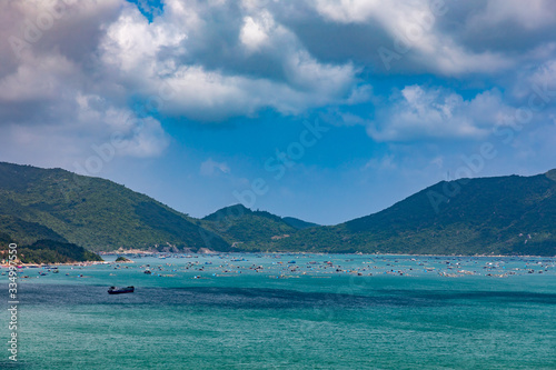 Fishing boats and freight ships in a bay in Vietnam