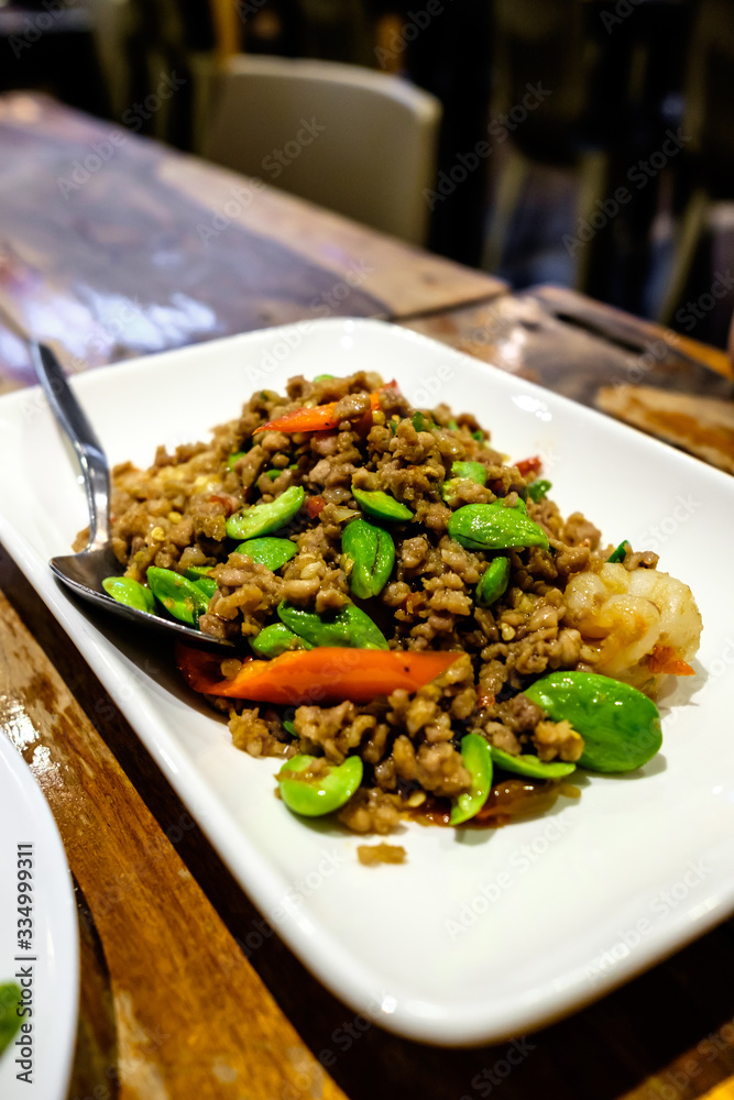 Stir-fried sator beans with shrimp and minced porks on a white plate Stir-fried sator beans with shrimp and minced porks on a white plate