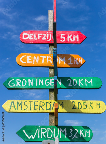 Colorful signpost pointing to various cities in Appingedam, Netherlands