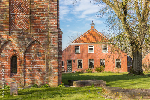Old farm house near the historic church of Krewerd, Netherlands photo