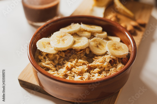 Oatmeal porridge with banana and almonds, healthy and nutrititious breakfast. 