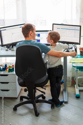 Father with kid working from home during quarantine. Stay at home, work from home concept during coronavirus pandemic